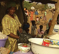 This woman in a marketplace is selling soumbala along with other traditional foods. Photo by Christian Costeaux.